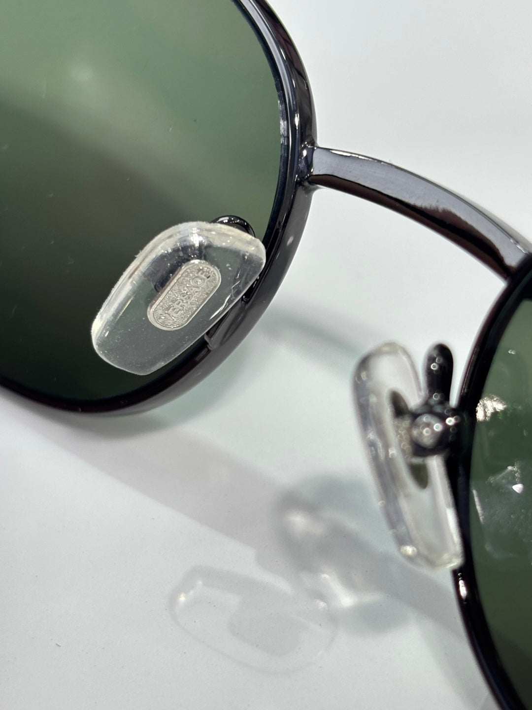 Versace glasses close-up of dark lens and clear temple with logo detail