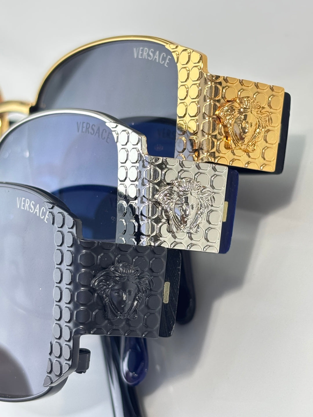 Versace glasses with engraved gold and silver frames and blue tinted lenses
