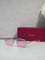 Cartier eyeglasses with gold-tone metal frame and pink gradient lenses, front view.
