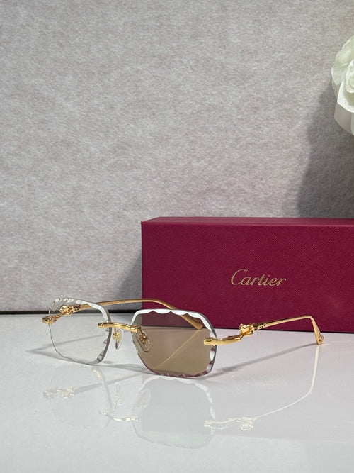 Cartier eyeglasses with gold-tone metal frame and pink-tinted lenses, front view.
