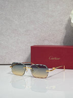 Cartier eyeglasses with gold-tone metal frame and amber-tinted lenses, angled view.