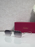 Cartier eyeglasses with gold-tone metal frame and dark smoked lenses, front view.
