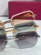 Close-up of gold and dark-tone eyeglass frames with tinted lenses and gold hinges.