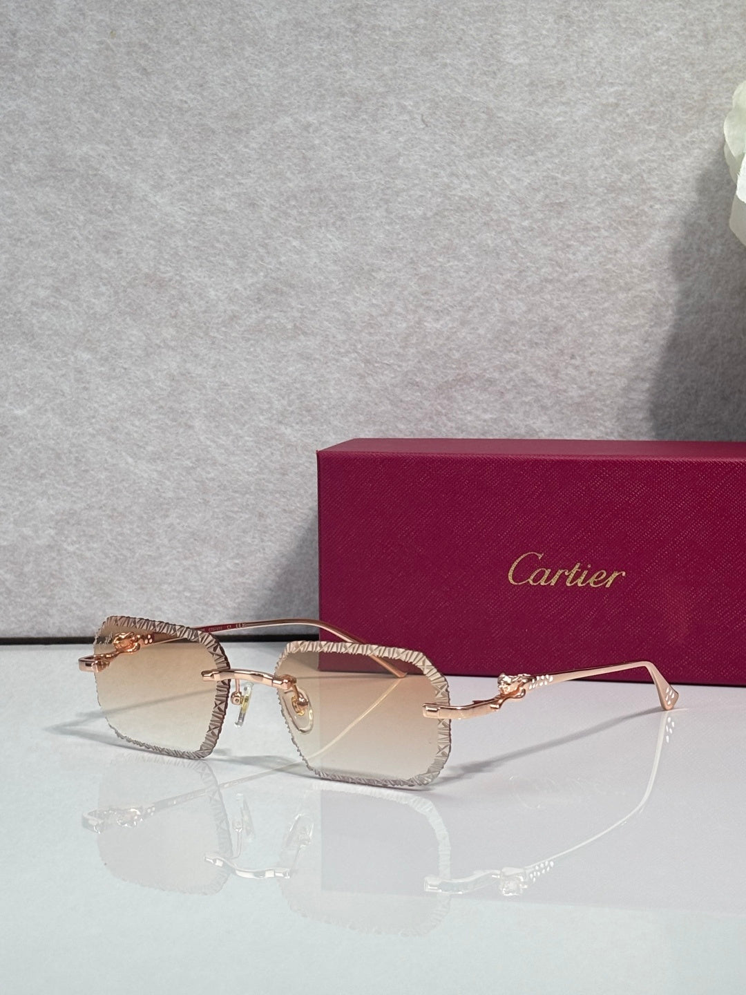 Rose-gold metal eyeglasses with gradient tinted lenses and textured temple details.