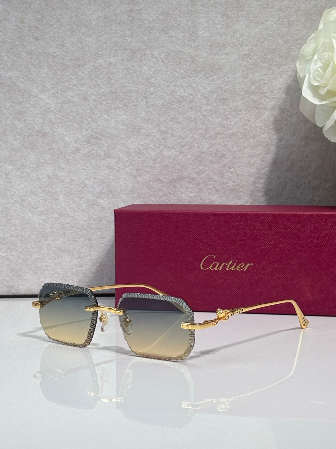 Dark-tone eyeglasses with smoky gray lenses and gold-tone metal frame accents.