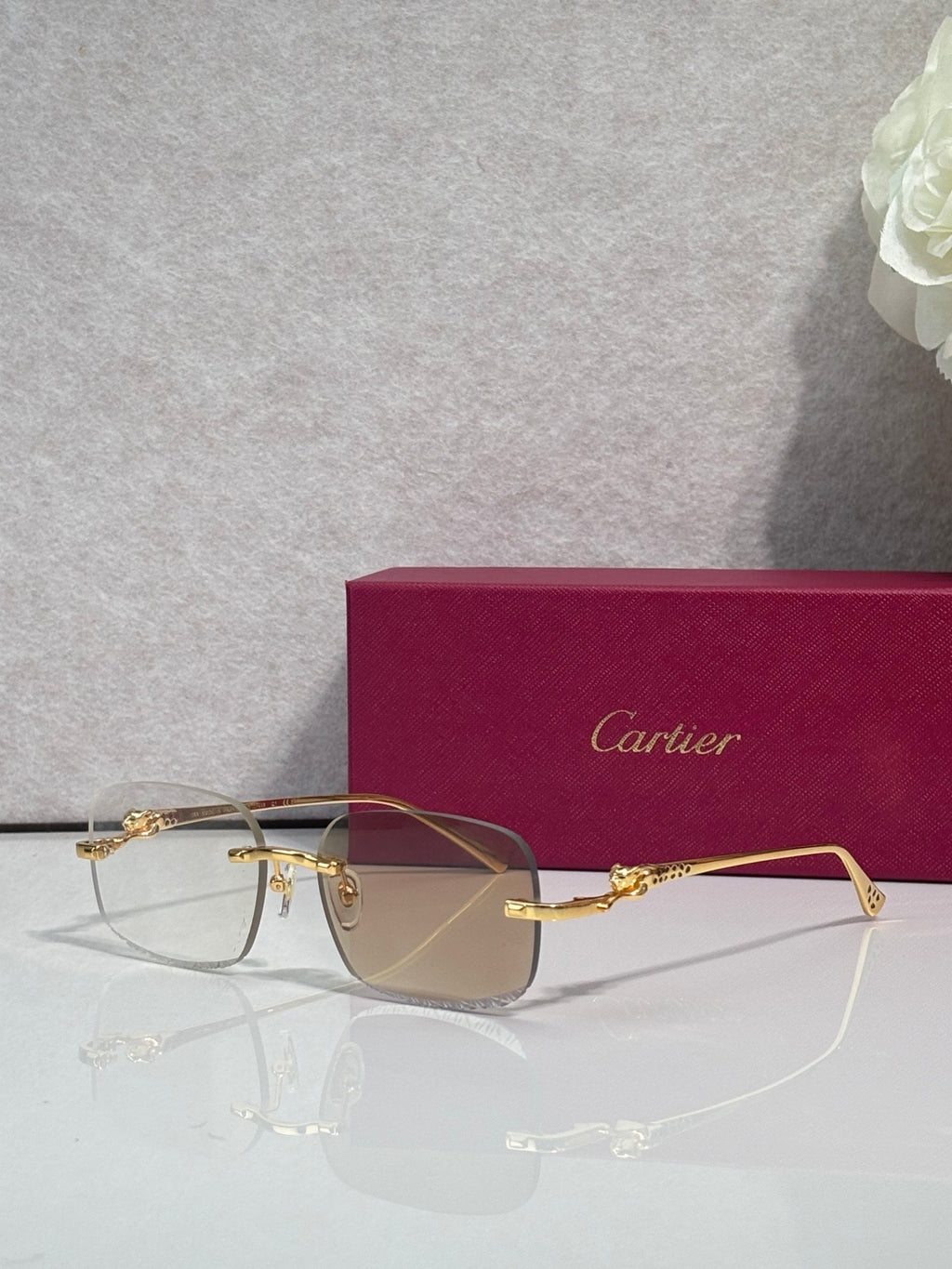 Cartier eyeglasses with gold-tone metal frame and tinted lenses, front view