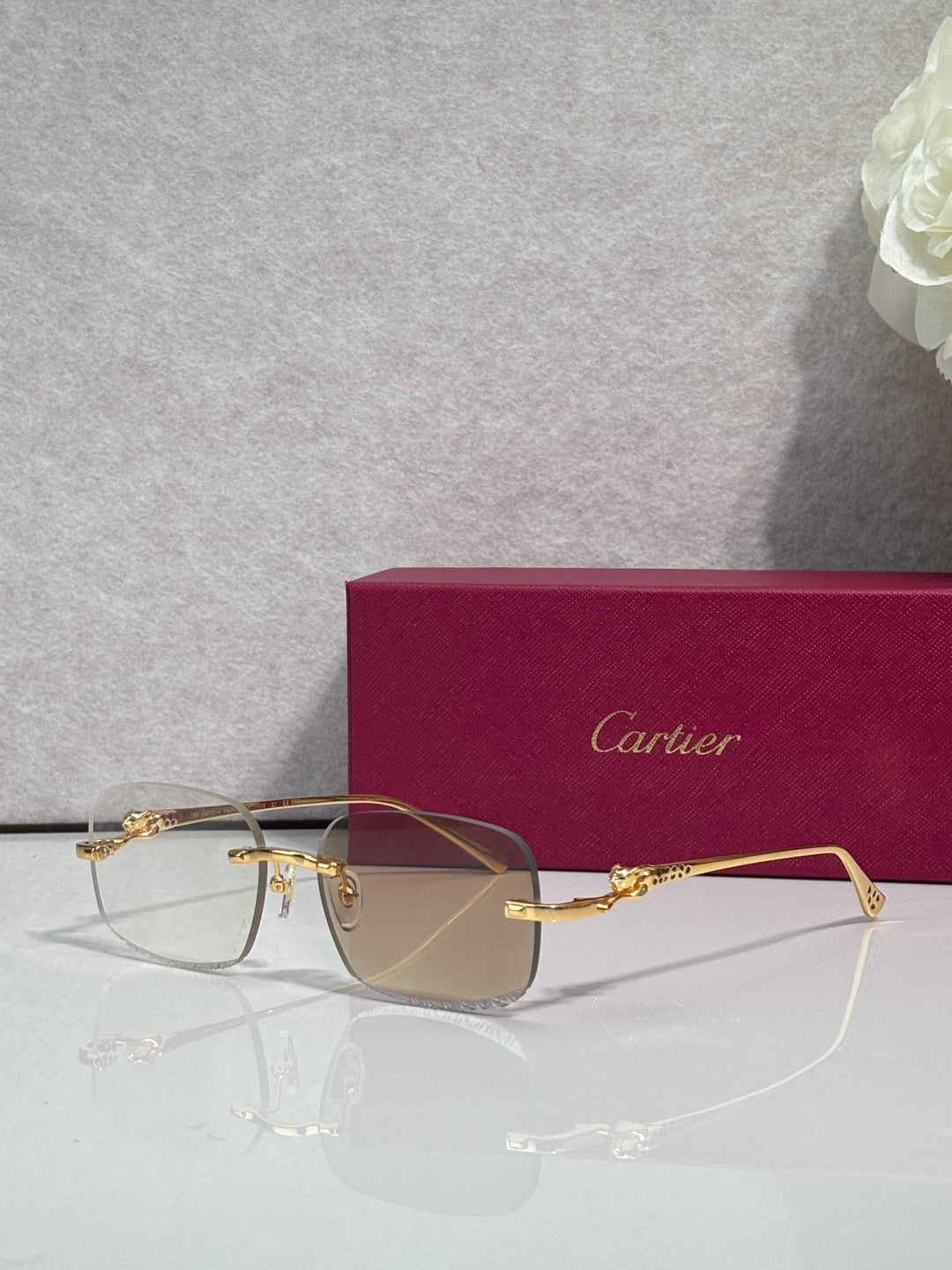 Cartier eyeglasses with gold-tone metal frame and tinted lenses, front view