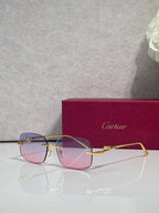 Cartier eyeglasses with gold-tone metal frame and tinted lenses, front view with reflections