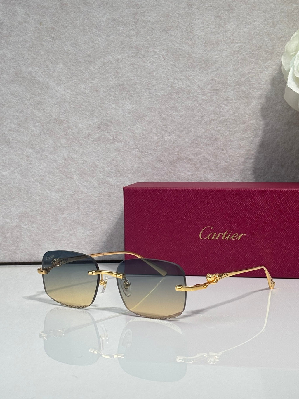 Cartier eyeglasses with dark-tone metal frame and tinted lenses, side-front view
