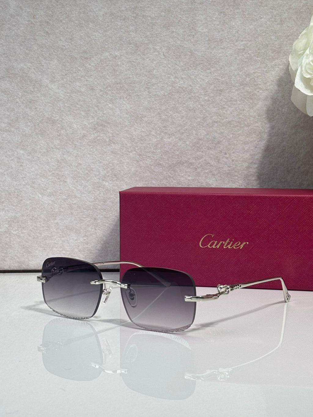 Cartier eyeglasses with dark-tone metal frame and tinted lenses, angled front view