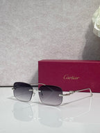 Cartier eyeglasses with dark-tone metal frame and tinted lenses, angled front view