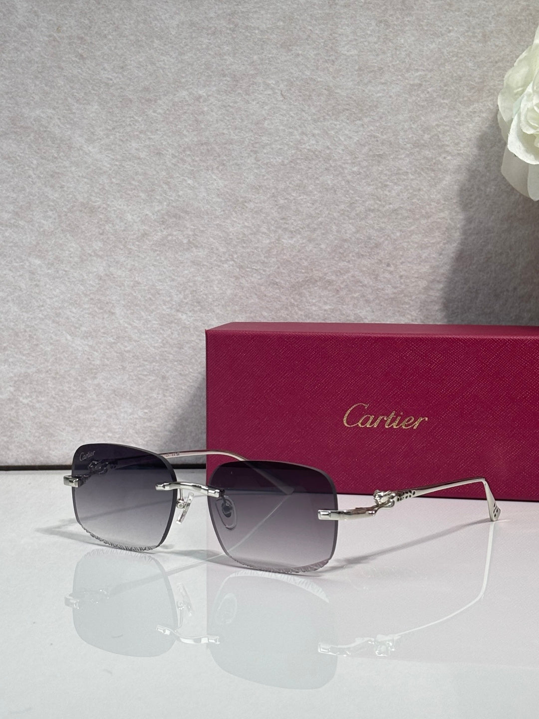 Cartier eyeglasses with dark-tone metal frame and tinted lenses, angled front view