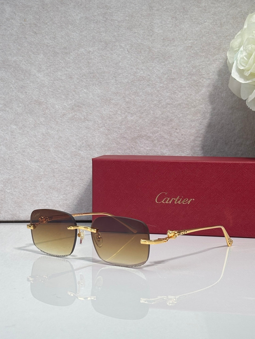 Cartier eyeglasses with gold-tone metal frame and lightly tinted lenses, side-front view