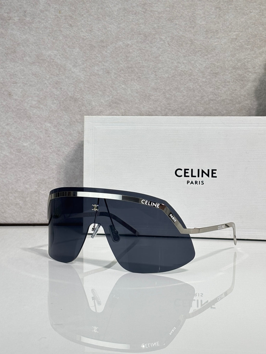 Celine sunglasses with navy lenses and silver metal frame, squared shield silhouette