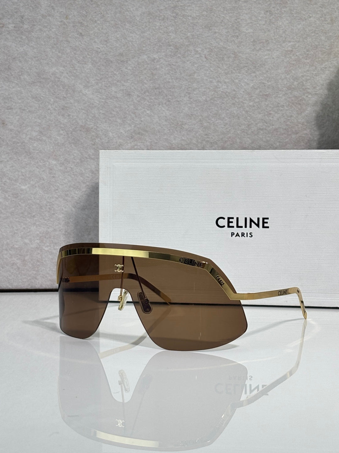 Celine sunglasses with brown-tinted lenses and gold-toned metal frame, oversized shield