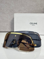 Celine sunglasses with dark blue lenses and gold-tone rim, oversized shield frame