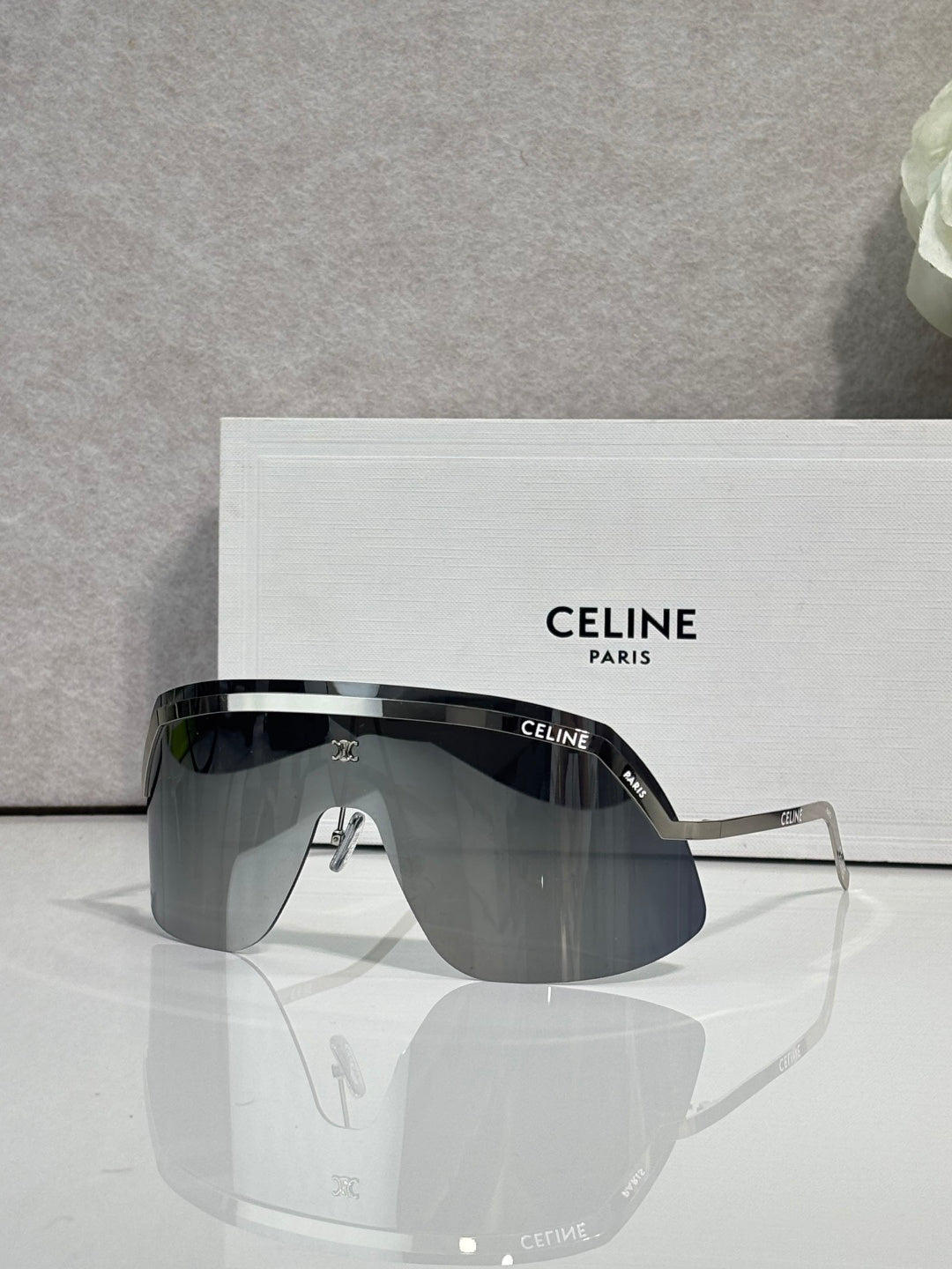 Celine sunglasses with dark gray lenses and silver metal frame, oversized shield shape