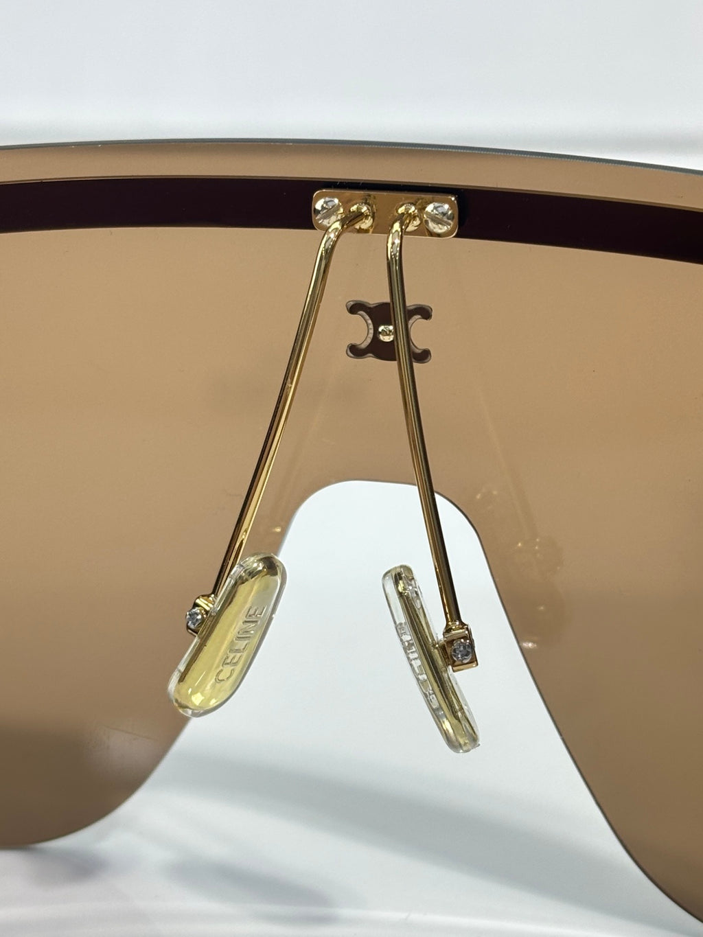 Celine sunglasses hinge detail with gold-toned metal and tinted lens edge