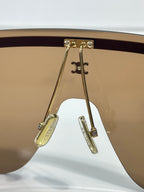 Celine sunglasses hinge detail with gold-toned metal and tinted lens edge