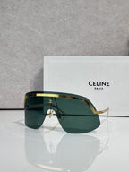 Celine sunglasses with green-tinted lenses and gold-toned metal frame, oversized shield