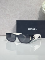 Chanel sunglasses with dark frames and white arms, rectangular lenses