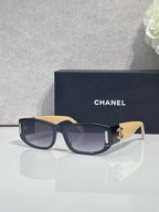 Chanel sunglasses with dark frames, cream arms, rectangular lenses