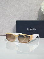 Chanel sunglasses with light frames, tan arms, rectangular lenses