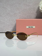 MiuMiu round sunglasses with brown lenses, gold-toned metal frame, logo on temples