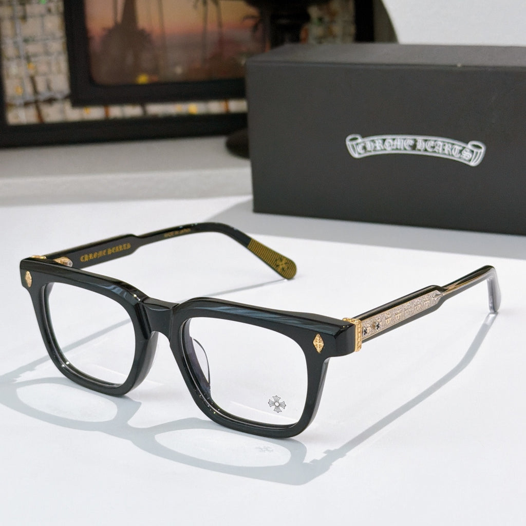 Black rectangular eyeglass frames with gold textured temple arms and clear lenses