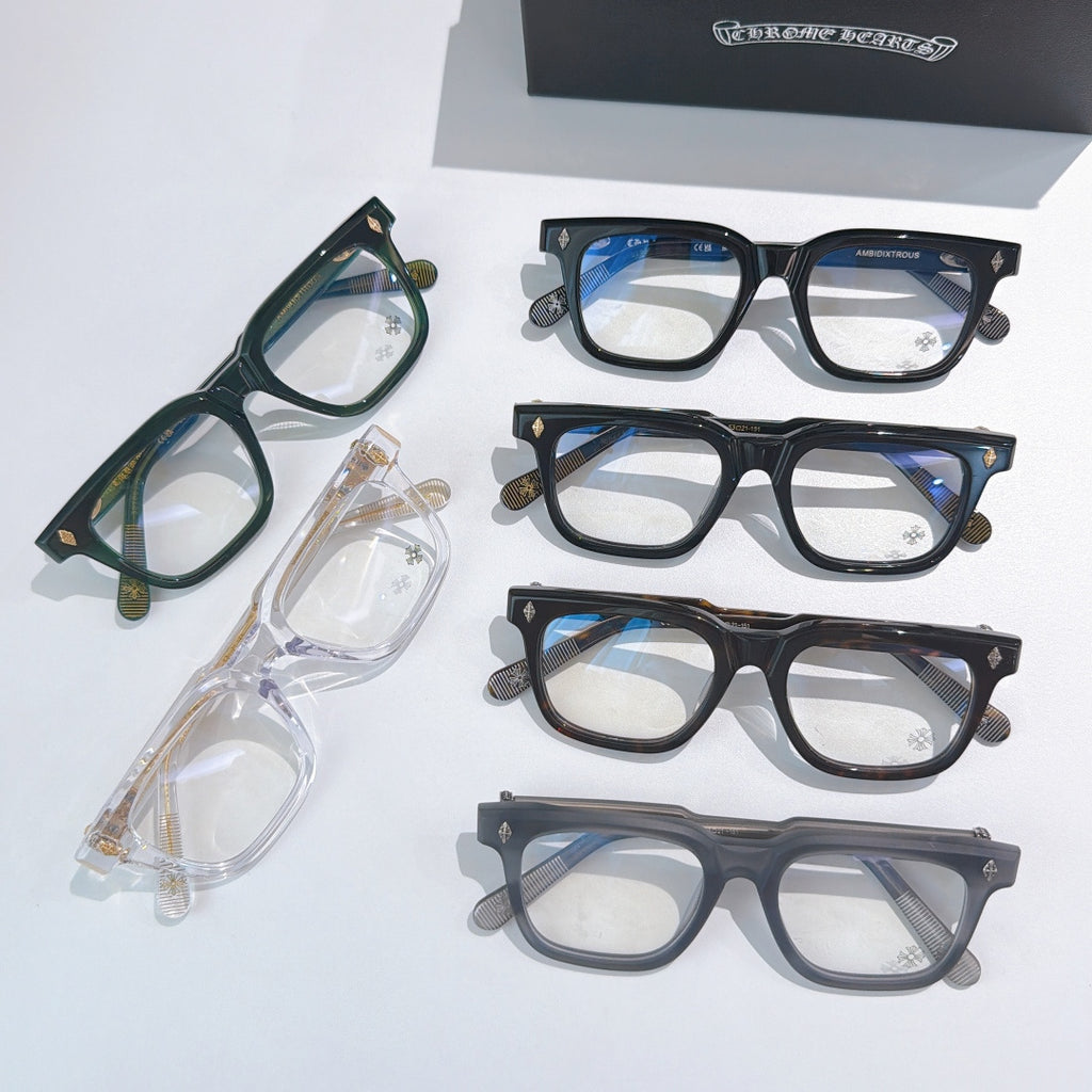 Assorted eyeglass frames in green, clear, blue, and dark tones with clear lenses