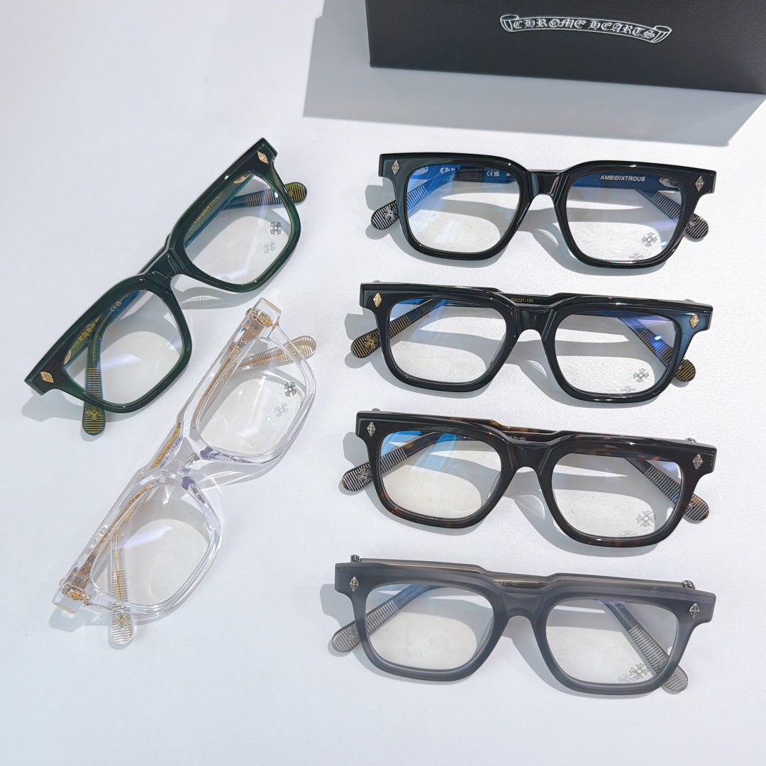 Assorted eyeglass frames in green, clear, blue, and dark tones with clear lenses