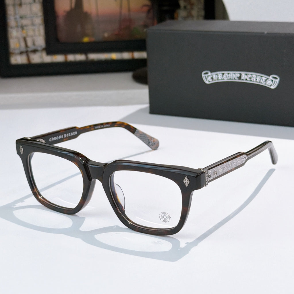 Dark tortoise and black rectangular eyeglass frames with gold temple accents and clear lenses