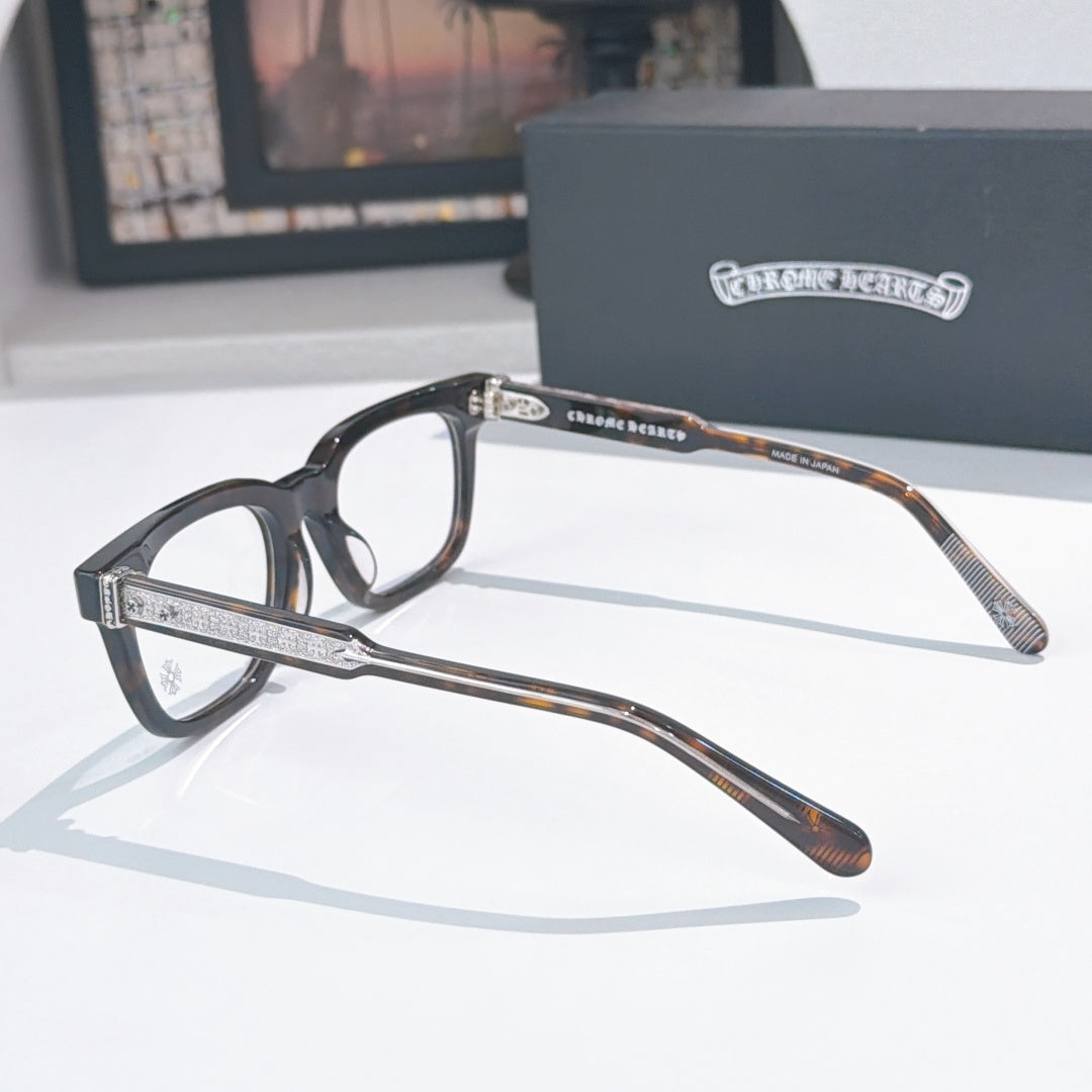 Black eyeglass frames with silver rhinestone-style temple bars and brown patterned arms