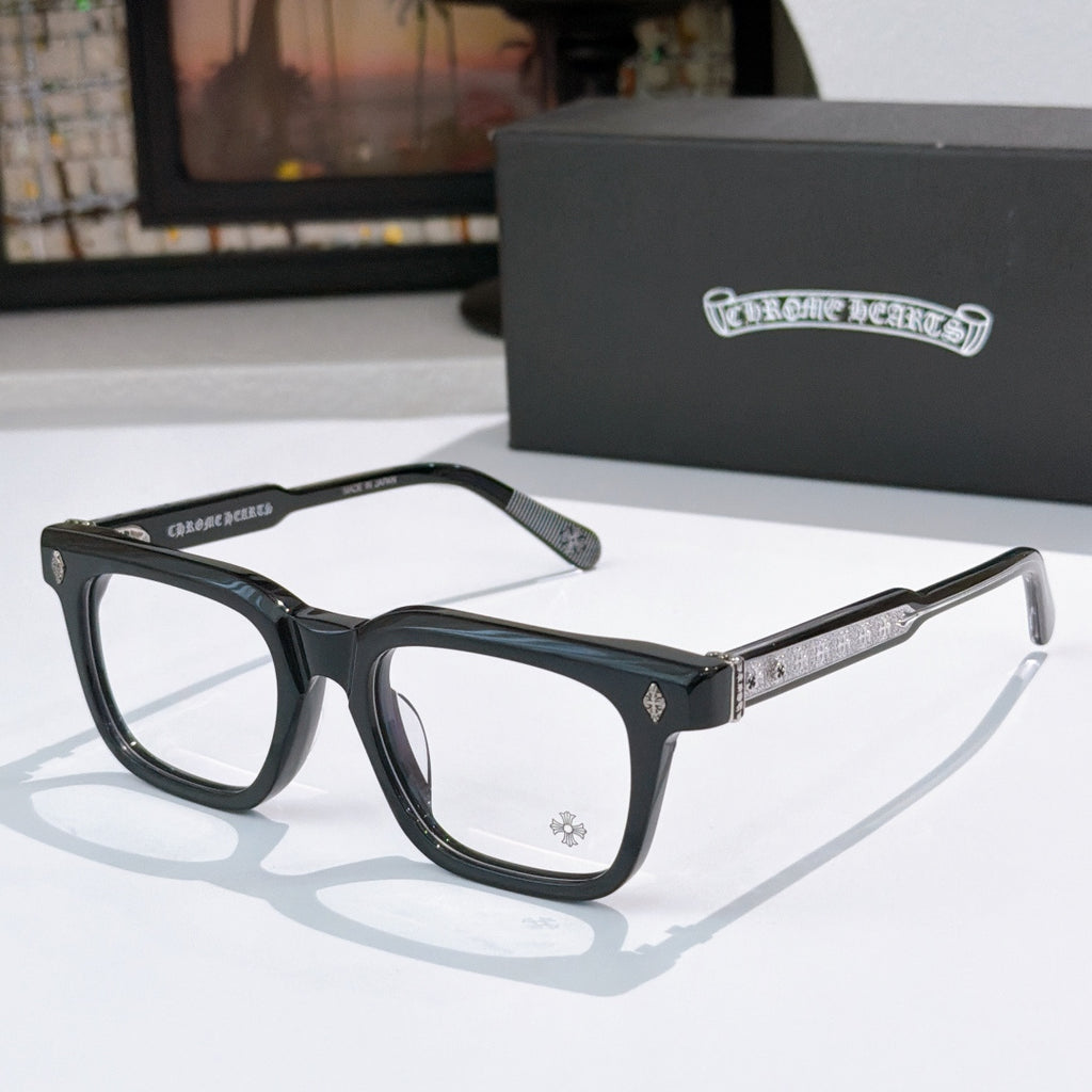 Black rectangular eyeglass frames with glittery silver-gold temple bars and clear lenses