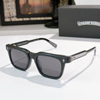 Chrome glasses with black frames and dark lenses, featuring patterned temple accents
