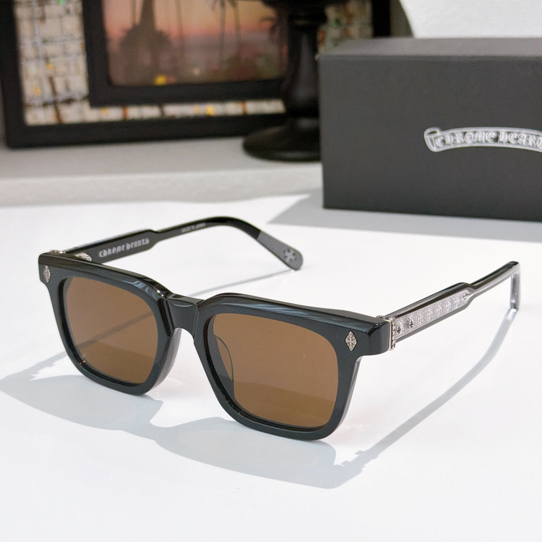 Chrome glasses with black frames, brown lenses, and patterned temple detailing