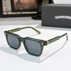 Chrome glasses with green frames, dark lenses, and patterned gold temple accents