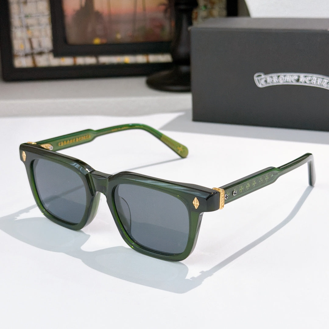 Chrome glasses with green frames, dark lenses, and patterned gold temple accents