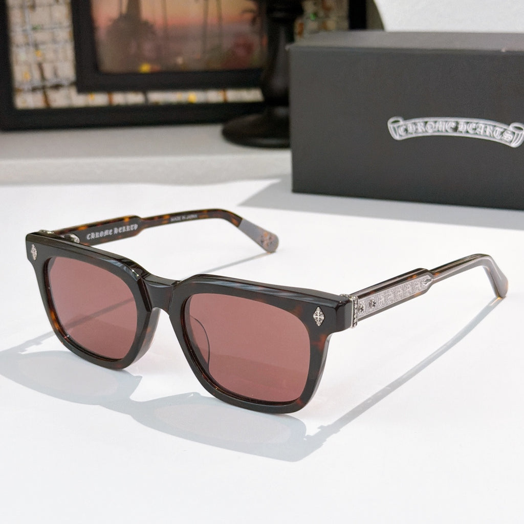 Chrome glasses with black frames and rose-brown lenses, with gold temple details