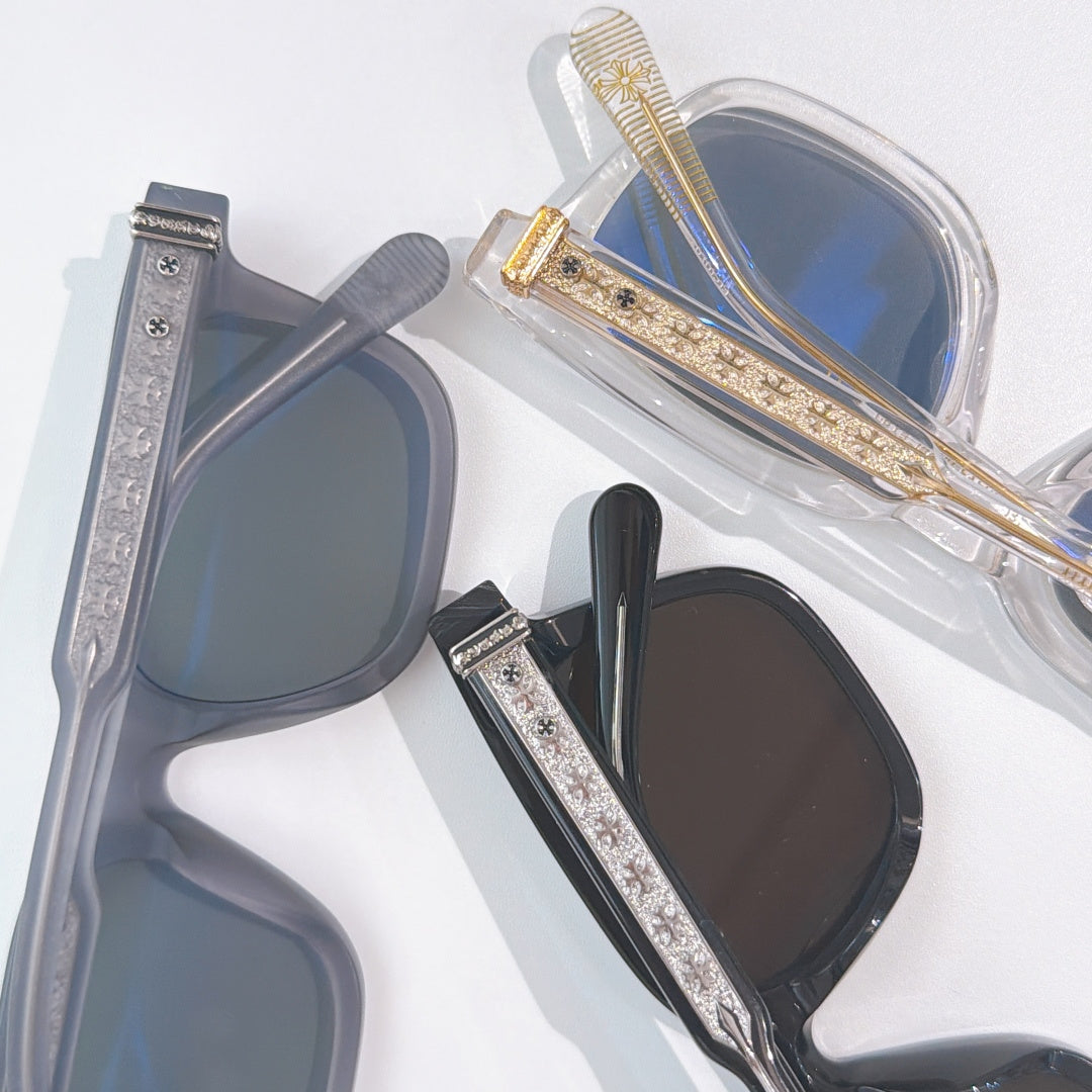 Chrome glasses close-up: clear frame with blue lenses and gold temple accents