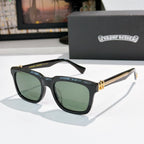 Black cat-eye sunglasses with green-tinted lenses and jeweled metal bridge