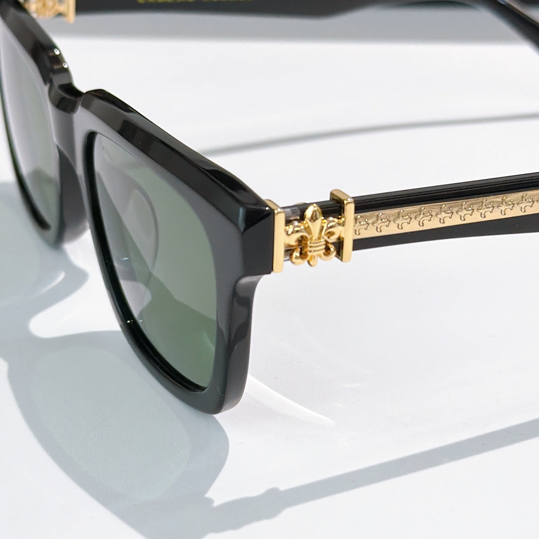Black cat-eye sunglasses side view with gold-tone hinge and temple pattern