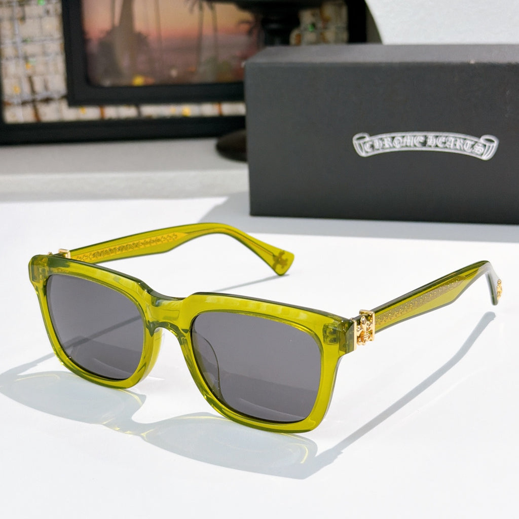Green transparent cat-eye sunglasses with dark lenses and jeweled temple detail