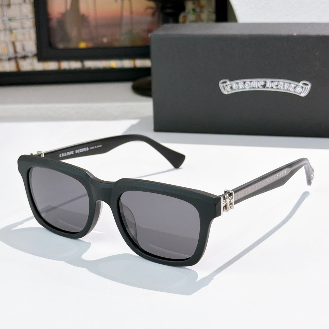 Black cat-eye sunglasses with gray lenses and jeweled metal bridge