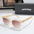 Gold-tone cat-eye sunglasses with pink-tinted lenses and textured temple detail