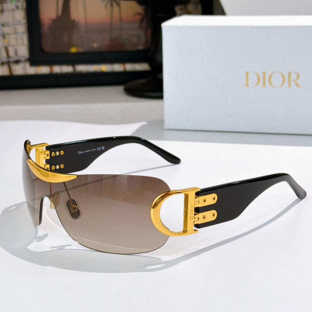 Dior sunglasses with gold accents, black temples, and tan tinted lenses