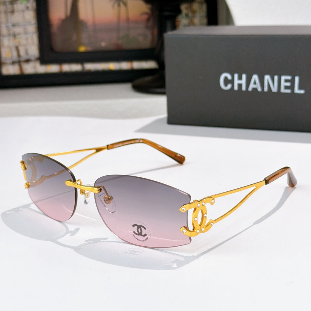Gold-tone aviator sunglasses with pink gradient lenses and Chanel emblem on the lens