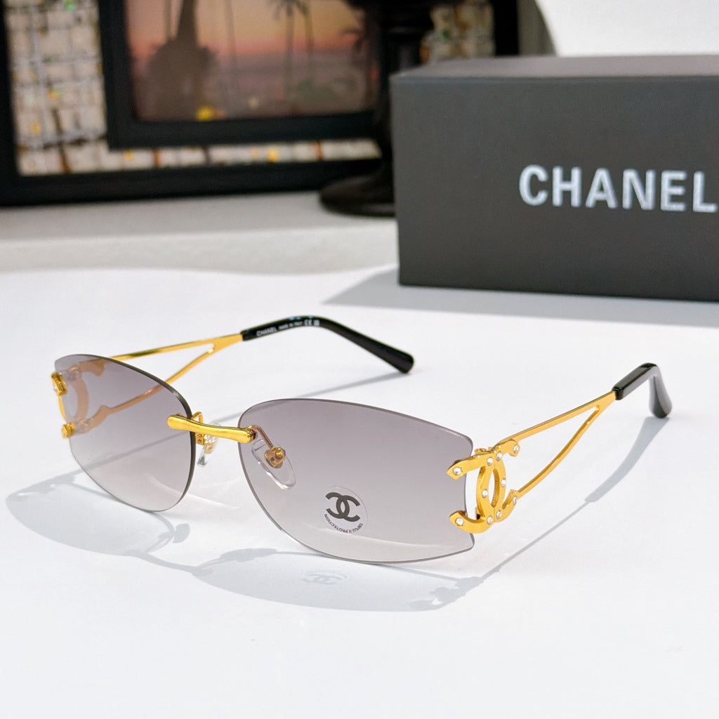 Gold-tone aviator sunglasses with light gray lenses and Chanel emblem on the lens