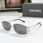 Silver aviator sunglasses with dark gray lenses and Chanel logo at the temple