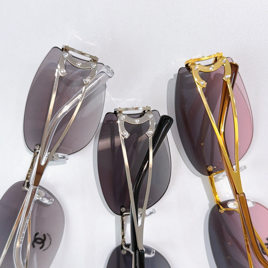 Assorted aviator sunglasses frames in silver, black, and gold with tinted lenses